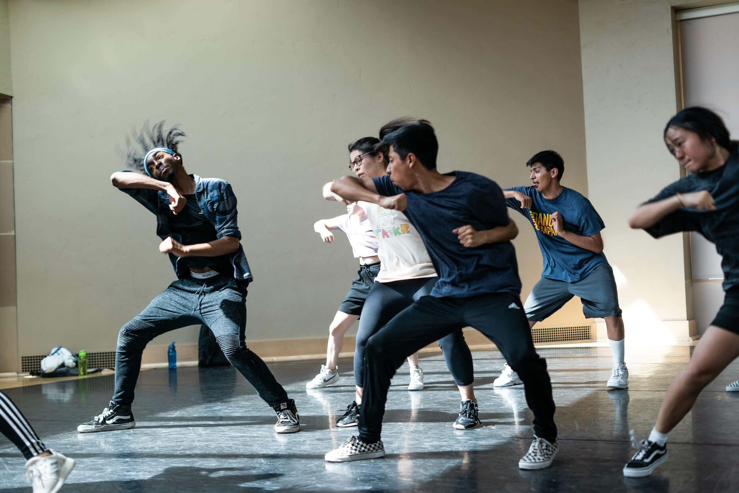 Group of hip-hop dancers learning choreography